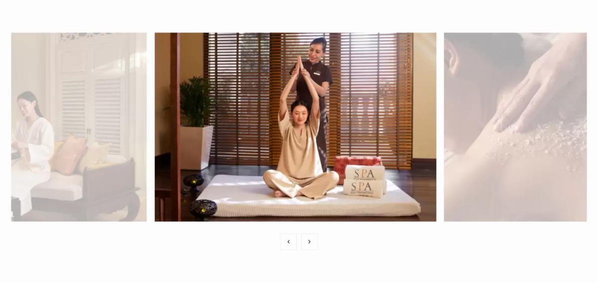 A three-column image slider layout on a hotel wellness page, showing a woman performing a yoga stretch on a mat with an instructor assisting her in front of a wooden blind backdrop.